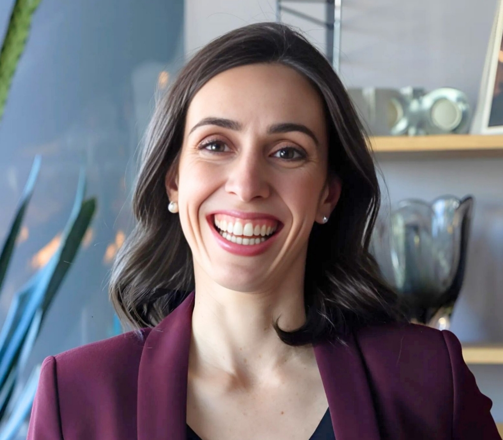 Holly Ransom professional headshot, leadership expert, future of work strategist, bestselling author, and keynote speaker, smiling in a burgundy blazer against a modern office background.