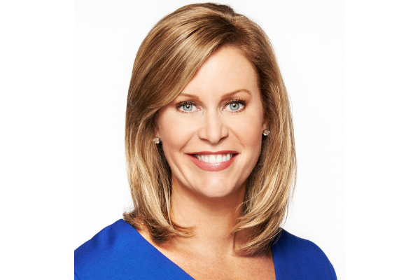 Stephanie Cutter in a blue blouse in front of a white background