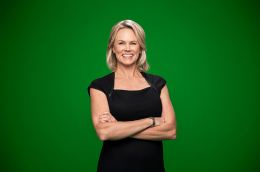 molly fletcher standing against green background