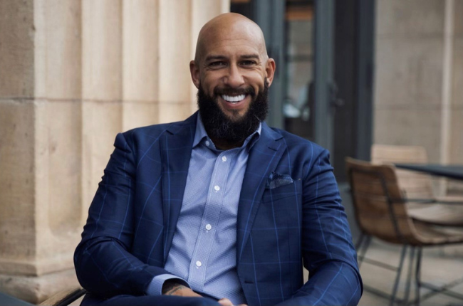 tim howard sitting in blue suit