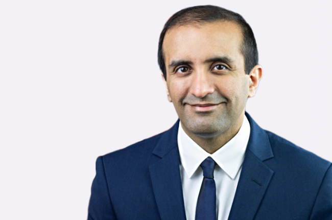 raj panjabi pictured smiling against a white background
