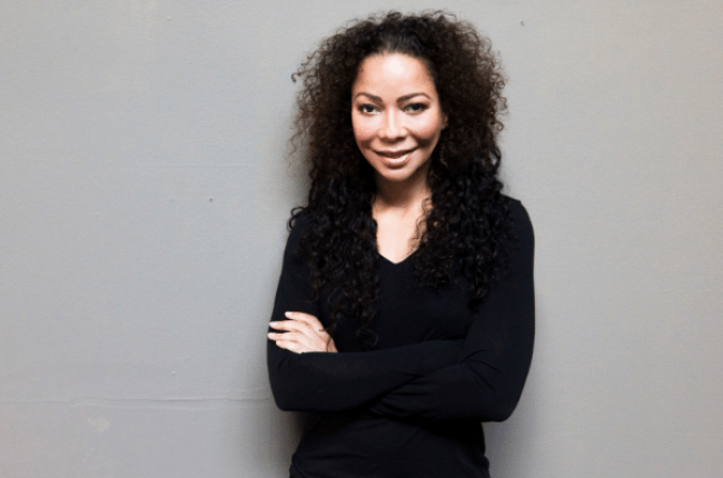 nichol bradford posing in black with her arms folded