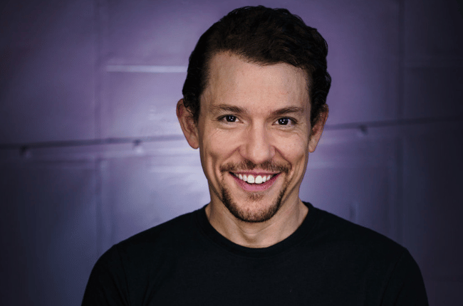 miguel cervantes smiling, wearing black shirt