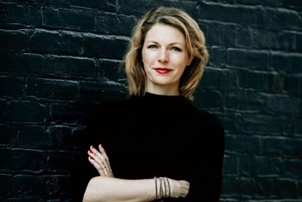 kate darling posing in a black shirt with her arms folded