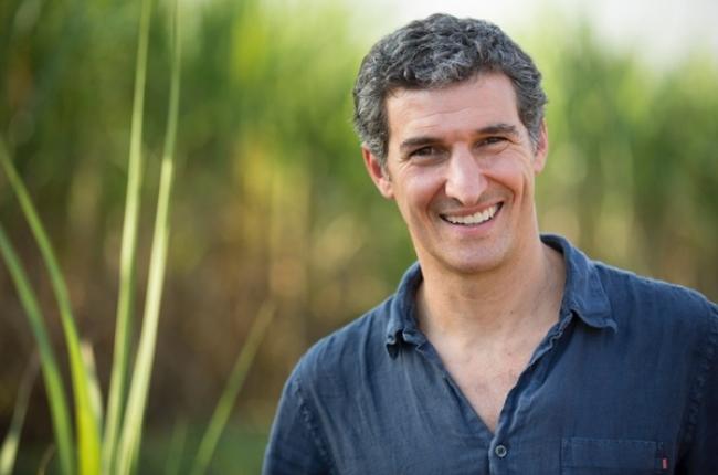seth goldman in the outdoors, with a collared shirt, smiling