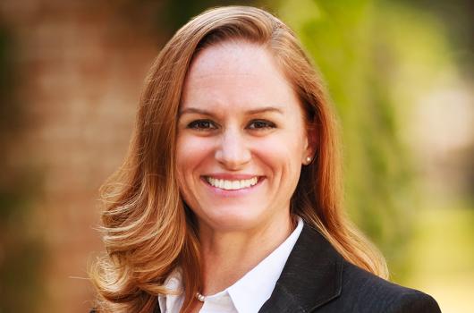 lisa jaster in a shirt and jacket, smiling, outdoors