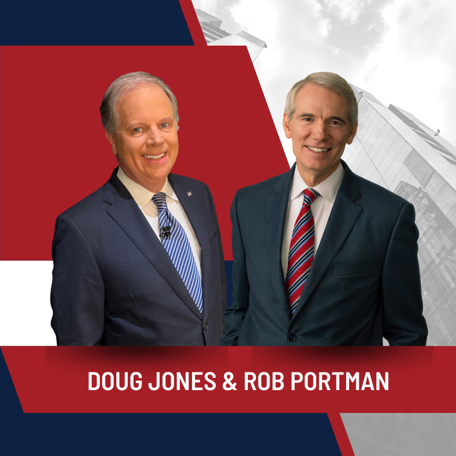 Doug Jones and Rom Portman smiling in front of a red and egg-white background