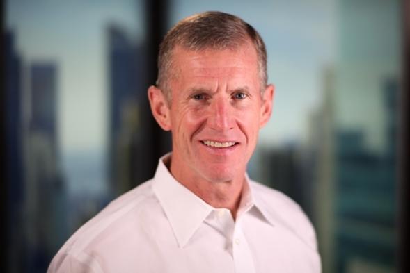 gen. mcchrystal posing in a white polo while smiling