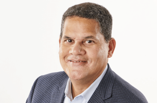 reggie fils-aime posing in front of a white background